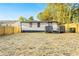 The backyard features a white house with dark trim, complemented by a wooden fence for added privacy at 358 Roy Sw St, Atlanta, GA 30310