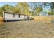 This backyard features a spacious grass area, privacy fence, and small deck, offering a serene retreat at 358 Roy Sw St, Atlanta, GA 30310