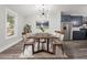 Elegant dining room features modern light fixture, seating for eight, and stainless steel appliances at 358 Roy Sw St, Atlanta, GA 30310