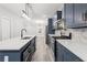 Galley kitchen featuring gray cabinets, stainless steel appliances, and a kitchen island at 358 Roy Sw St, Atlanta, GA 30310