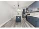 A long view of the galley kitchen featuring gray cabinets, a white countertop, and stainless appliances at 358 Roy Sw St, Atlanta, GA 30310