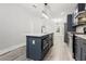 Kitchen island with stainless steel sink, faucet, and appliances with gray cabinets at 358 Roy Sw St, Atlanta, GA 30310