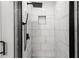 Modern shower with white marble tile and black fixtures at 358 Roy Sw St, Atlanta, GA 30310