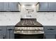 Stainless steel gas cooktop with pot filler faucet and white quartz countertops at 358 Roy Sw St, Atlanta, GA 30310