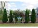 Beautiful backyard featuring an arbor leading to a pool, framed by manicured greenery and mature trees at 3811 Valley Green Dr, Marietta, GA 30068