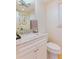 Well-lit half bathroom with marble countertop, white cabinets, and a decorative mirror at 3811 Valley Green Dr, Marietta, GA 30068