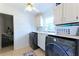 Well-lit laundry room with front-loading washer and dryer, a sink, and built-in cabinets at 3811 Valley Green Dr, Marietta, GA 30068