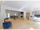 Open-concept living area with hardwood floors, featuring a cozy living room, a fireplace, and a study area at 3811 Valley Green Dr, Marietta, GA 30068
