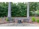 Outdoor patio with charming table and chairs, surrounded by lush greenery for peaceful outdoor dining and relaxation at 3811 Valley Green Dr, Marietta, GA 30068