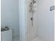 Modern tiled shower with glass enclosure and built-in storage at 3811 Valley Green Dr, Marietta, GA 30068