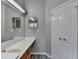 Well-lit bathroom featuring a spacious vanity, large mirror and plank flooring at 2274 Stancrest Ln, Lawrenceville, GA 30044