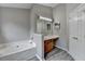 Well-appointed bathroom featuring a tub, vanity, and gray plank flooring at 2274 Stancrest Ln, Lawrenceville, GA 30044