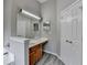 Bathroom featuring a vanity with wooden cabinets, spacious countertops, and gray plank flooring at 2274 Stancrest Ln, Lawrenceville, GA 30044