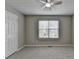 Bedroom featuring neutral carpet, a ceiling fan, and a window for natural light at 2274 Stancrest Ln, Lawrenceville, GA 30044