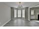 Dining area features a modern chandelier, neutral colors, and a bright bay window, ideal for Gathering gatherings at 2274 Stancrest Ln, Lawrenceville, GA 30044