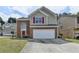 Charming two-story home featuring a brick facade, red shutters, and an attached two-car garage at 2274 Stancrest Ln, Lawrenceville, GA 30044