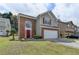 Lovely exterior view of a two-story home with brick and siding, a well-manicured lawn, and mature trees at 2274 Stancrest Ln, Lawrenceville, GA 30044