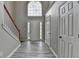 Bright foyer featuring a chandelier, staircase, and beautiful gray wood-look floors at 2274 Stancrest Ln, Lawrenceville, GA 30044