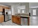 Modern kitchen with stainless appliances and view into adjacent living area at 2274 Stancrest Ln, Lawrenceville, GA 30044
