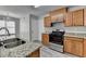 This updated kitchen includes a serving hatch, stainless appliances and new wood flooring at 2274 Stancrest Ln, Lawrenceville, GA 30044