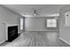 Cozy living room with a classic fireplace and ceiling fan creates a comfortable space to relax and unwind at 2274 Stancrest Ln, Lawrenceville, GA 30044
