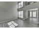 Bright living room featuring soaring ceilings, large windows, and elegant gray wood-look floors at 2274 Stancrest Ln, Lawrenceville, GA 30044