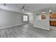 Bright living room with modern light fixture offers a seamless flow into the nearby kitchen area at 2274 Stancrest Ln, Lawrenceville, GA 30044