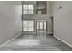 Spacious living room boasting soaring ceilings, large windows, and elegant gray wood-look floors at 2274 Stancrest Ln, Lawrenceville, GA 30044