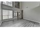 Bright living room featuring soaring ceilings, large windows, and elegant gray wood-look floors at 2274 Stancrest Ln, Lawrenceville, GA 30044
