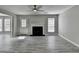 Well-lit living room with gray flooring, a cozy fireplace, and bright windows at 2274 Stancrest Ln, Lawrenceville, GA 30044