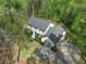 Stunning aerial view of a two-story home with mature landscaping and a private, wooded lot at 292 Old Rosser Rd, Stone Mountain, GA 30087