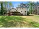 Spacious backyard featuring a deck, stairs, and lush green lawn at 292 Old Rosser Rd, Stone Mountain, GA 30087