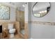 Neutral bathroom with a glass-enclosed shower and patterned accent tiles at 292 Old Rosser Rd, Stone Mountain, GA 30087