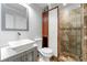 Updated bathroom featuring a glass door shower, modern vanity, and tiled walls at 292 Old Rosser Rd, Stone Mountain, GA 30087