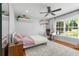 Bedroom showcasing a ceiling fan, desk area and large window offering plenty of natural light at 292 Old Rosser Rd, Stone Mountain, GA 30087
