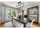 Modern dining area with a large window offering wooded backyard views and display case at 292 Old Rosser Rd, Stone Mountain, GA 30087