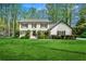 Charming two-story home with lush green lawn, manicured shrubs, and black shutters at 292 Old Rosser Rd, Stone Mountain, GA 30087