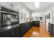 Well-lit kitchen with stainless steel appliances, sleek cabinetry, and hardwood floors, great flow to breakfast nook at 292 Old Rosser Rd, Stone Mountain, GA 30087