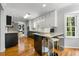 Charming kitchen with stainless steel appliances, white cabinets, and breakfast bar, ideal for casual dining at 292 Old Rosser Rd, Stone Mountain, GA 30087