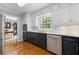 Modern kitchen featuring stainless steel appliances, white backsplash, and dark cabinetry with hardwood floors at 292 Old Rosser Rd, Stone Mountain, GA 30087