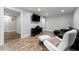 Cozy living room featuring modern decor, sleek furniture, and warm wood-look tile flooring at 292 Old Rosser Rd, Stone Mountain, GA 30087