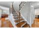 Elegant staircase with wood treads and wrought iron spindles leading to the upper level at 292 Old Rosser Rd, Stone Mountain, GA 30087