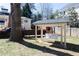 Inviting backyard featuring a charming swing under a covered area, perfect for relaxation and outdoor enjoyment at 139 W Paces Ferry Nw Rd, Atlanta, GA 30305