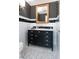 Elegant bathroom with black and white tile, stylish wallpaper, and a vanity with decorative hardware at 139 W Paces Ferry Nw Rd, Atlanta, GA 30305