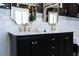 Bathroom featuring a vanity with dual sinks, marble countertops, tiled backsplash, and sleek fixtures at 139 W Paces Ferry Nw Rd, Atlanta, GA 30305