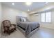 Bedroom featuring a gray upholstered bed and chair complemented by a bright window at 139 W Paces Ferry Nw Rd, Atlanta, GA 30305