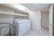 Bright laundry room area with white washer and dryer, white trim, and door to adjacent room at 139 W Paces Ferry Nw Rd, Atlanta, GA 30305