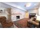 Cozy living room with exposed brick fireplace, area rug, and comfortable seating at 139 W Paces Ferry Nw Rd, Atlanta, GA 30305