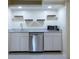 An elegant wet bar features a sink, stainless steel dishwasher, microwave, granite countertops and open shelves at 139 W Paces Ferry Nw Rd, Atlanta, GA 30305
