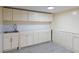 Basement wet bar with neutral cabinets, stainless sink, white subway tile backsplash, and tile floors at 139 W Paces Ferry Nw Rd, Atlanta, GA 30305